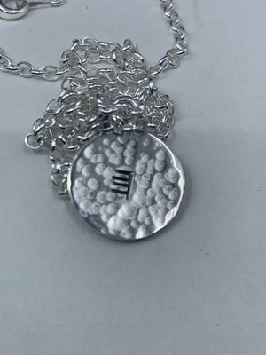 Carved initial disc - Ogham Treasure