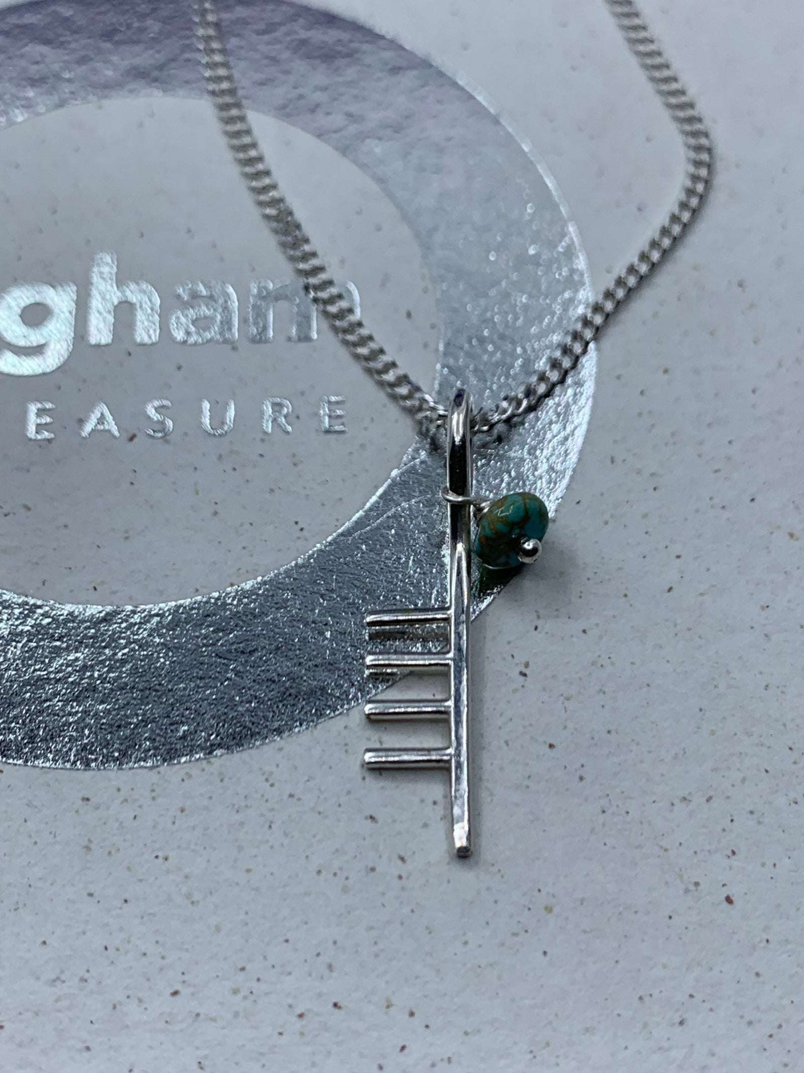 Inital C with turquoise